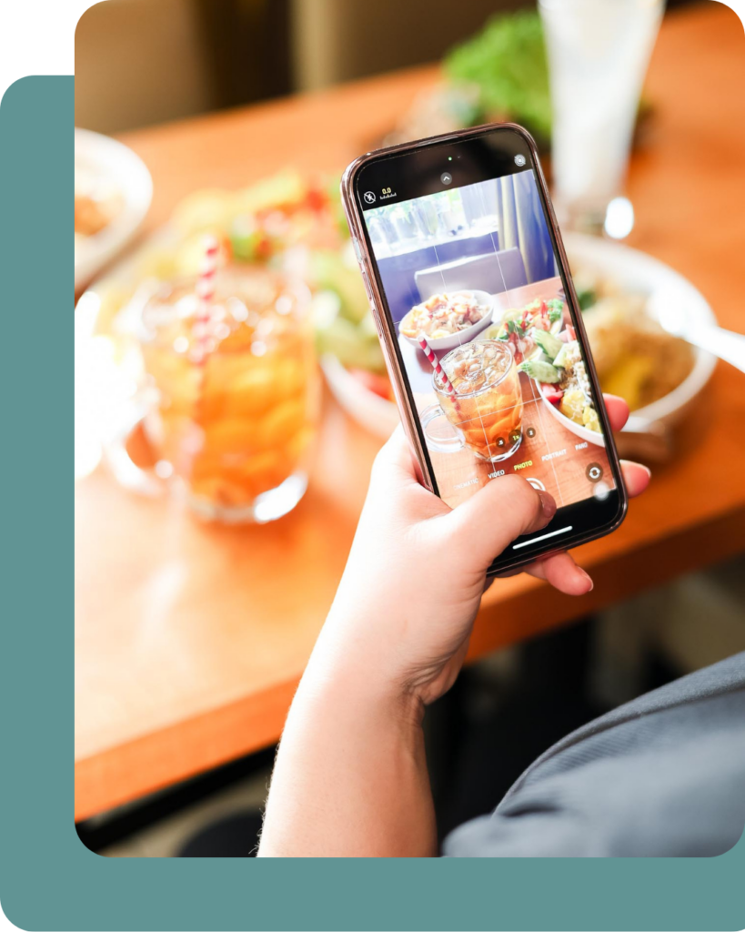 Person photographing food and drinks